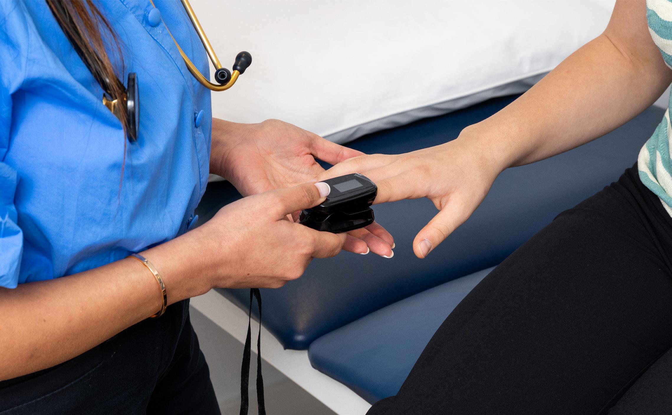 A General Practitioner near Malvern East checks patient oxygen with pulse oximeter for care that fits your lifestyle.